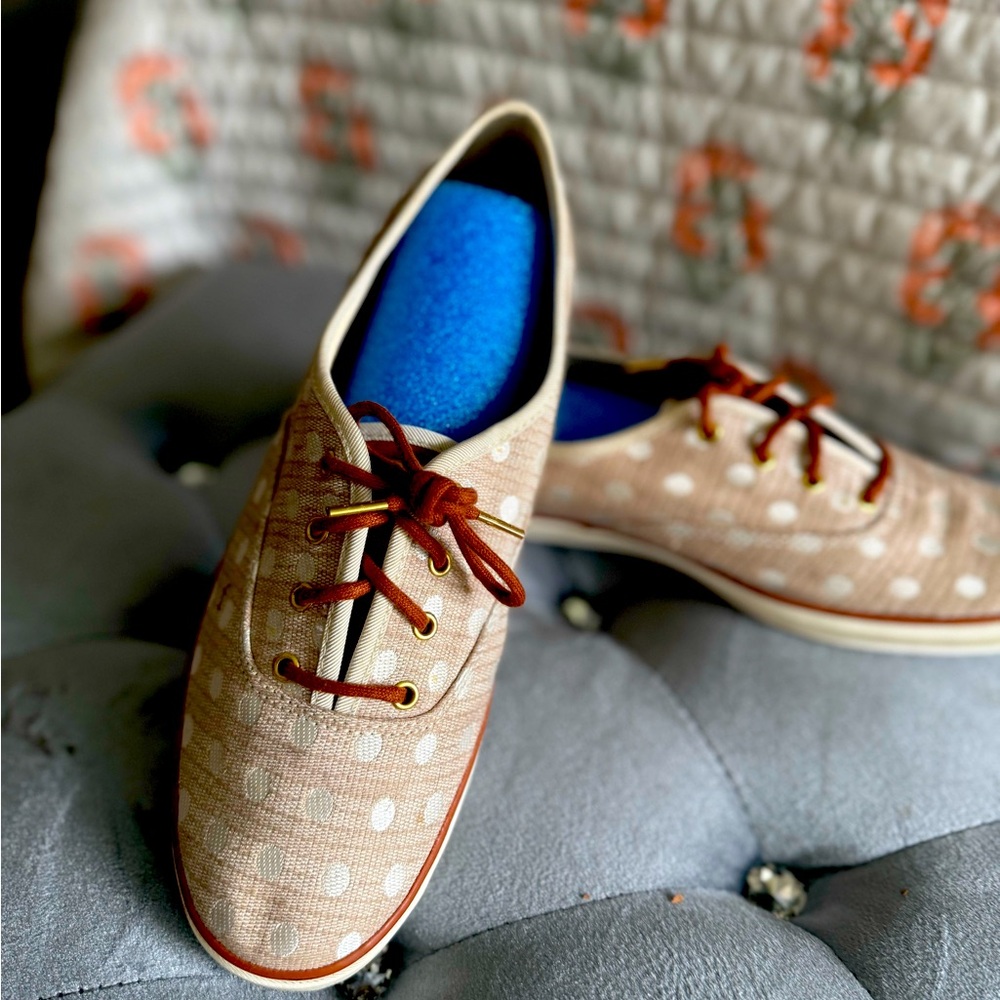 Tan women’s Keds with white polka dots.
